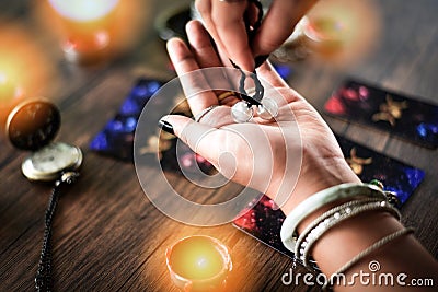 Fortune teller reading fortune lines on hand Palmistry Psychic readings and clairvoyance hands with Tarot cards divination Stock Photo