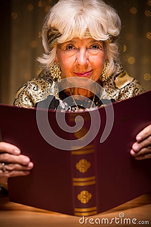 Fortune teller reading magic book Stock Photo