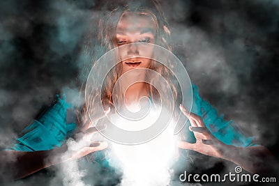 Fortune teller woman with light sphere in her hands Stock Photo