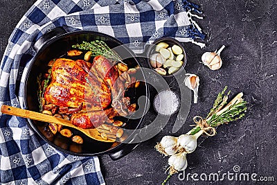 Forty cloves chicken in a black baking dish Stock Photo