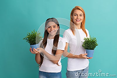 Fostering and adoption. Happy adopted child and mother hold houseplants. Foster family. Fostering Stock Photo