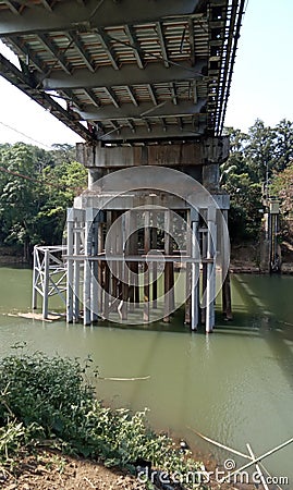 The foundation of the bridge supporting pillars is firmly anchored to the river bed Stock Photo