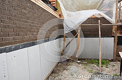 Foundation foam insulation and Damp proofing in problem corner area. House basement, foundation foam insulation details with Stock Photo