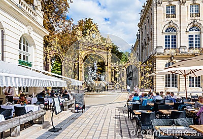 Fountain of Amphitrite and sidewalk restaurant on the Stanislas square in Nancy, France Editorial Stock Photo