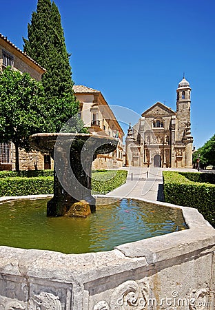 Fountain with church to the rera, Ubeda, Spain. Editorial Stock Photo