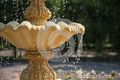 Fountain element close-up. The concept of summer freshness and vacation. Flying drops of water. Stock Photo