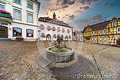 Fountain made of copper in the middle of the old marketplace with half-timbered houses and the town hall in the background in Linz Editorial Stock Photo