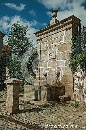 Fountain made of stone with small water spout Stock Photo
