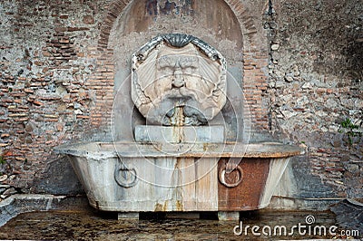 Fountain of the Mask Fontana Del Mascherone by Giacomo della Porta 1532-1602 in the Piazza Pietro d`Illiria on the Aventine Stock Photo