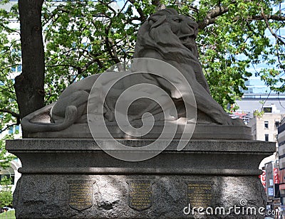 Fountain-monument is composed of a pedestal, with a lion lying on top Editorial Stock Photo