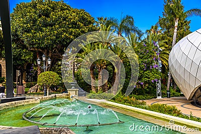 Fountain with palms in park of La Condamine, Monte-Carlo, Monaco, Cote d `Azur, French Riviera Editorial Stock Photo