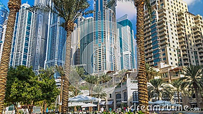 Fountain and palms timelapse at the Marina walk, During day time. Dubai, UAE Editorial Stock Photo