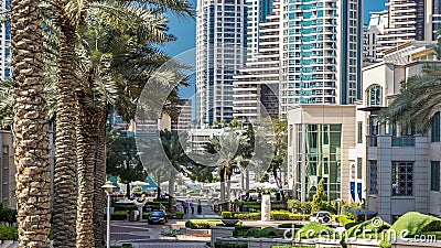 Fountain and palms timelapse at the Marina walk, During day time. Dubai, UAE Editorial Stock Photo