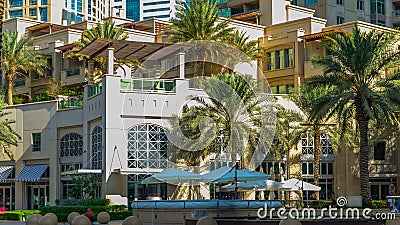 Fountain and palms timelapse at the Marina walk, During day time. Dubai, UAE Editorial Stock Photo