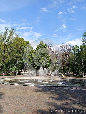 fountain in the park, leaves, green, white clouds on the blue sky, for postcards, business cards Editorial Stock Photo