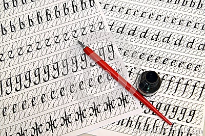 The fountain pen and black ink lie on sheets of calligraphical copy-books Stock Photo