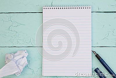 Fountain pen and blank paper on turquoise rustic wood table Stock Photo