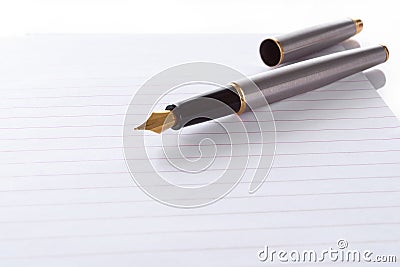 Fountain pen lying on page in a spiral bound notep Stock Photo