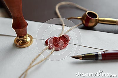 Fountain pen and old notarial wax seal on document, closeup Stock Photo
