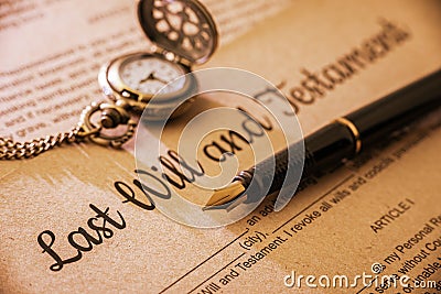 Fountain pen, a pocket watch on a last will and testament. Stock Photo