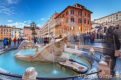 Fountain on the Piazza di Spagna square and the Spanish Steps in Rome at dusk, Italy Editorial Stock Photo