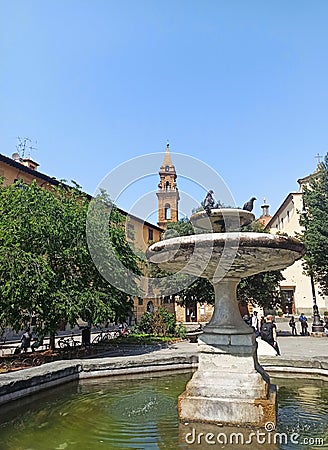 The fountain in Piazza Oltrarno in front of the Basilica of the Holy Spirit in Florence, Italy. Stock Photo