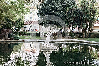 Fountain or pond with statue in Lisbon. Landscaping or architecture or park and garden. Antique statue in water or Editorial Stock Photo