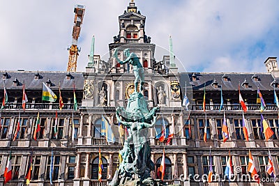 Fountain statue of Brabo throwing the severed hand of Antigoon into the Scheldt river with belfry of the Cathedral of our Lady, Editorial Stock Photo