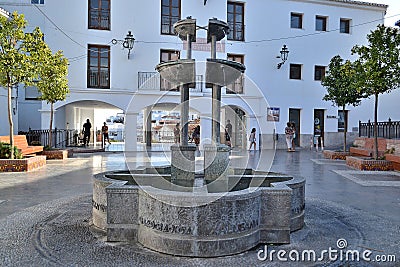 Fountain in the town Hall Square which is a wrought iron pillar with four taps and their respective cups Stock Photo