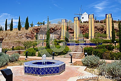 Fountain with wimdmill to the rear, Castro Marim. Stock Photo