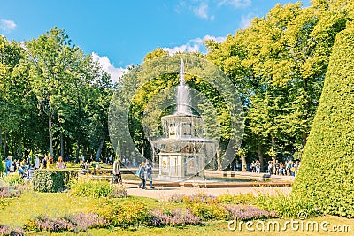 Fountains of Peterhof. View of Roman fountains in Lower park of Peterhof. Beautiful garden with green grass, shrubs and Editorial Stock Photo