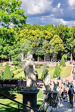 Fountains of Peterhof. View of Roman fountains in Lower park of Peterhof. Beautiful garden with green grass, shrubs and Editorial Stock Photo