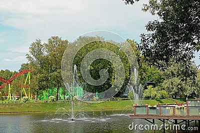 Fountains on the water in the Park among the green vegetation Stock Photo