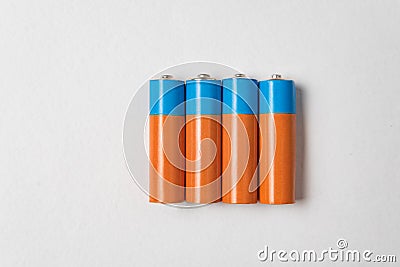 Four AA alkaline batteries on white background. Main battery for personal power supplies Stock Photo