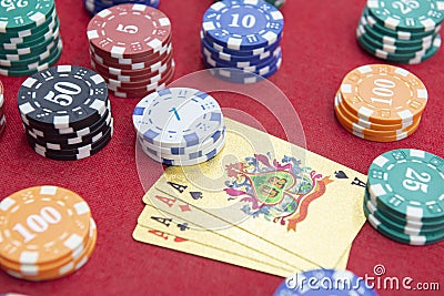 Four of aces near stacks of chips on a red felt table Stock Photo