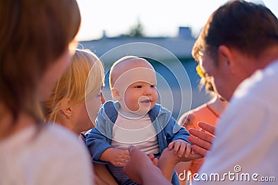 Four adults care about baby Stock Photo