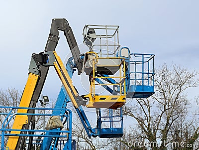 Four aerial working platforms of cherry picker. Overcast sky. Stock Photo