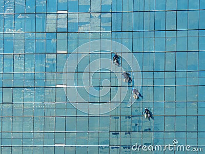 Four alpinist climbing for cleaning the building window glass Stock Photo