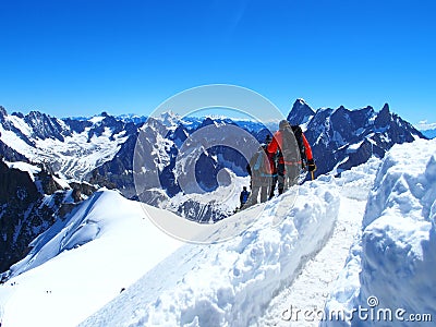 Four alpinists and mountaineer climbers in french Alps, AIGUILLE DU MIDI, FRANCE Stock Photo