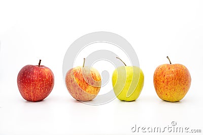 Four apples in a row with three red apples Stock Photo