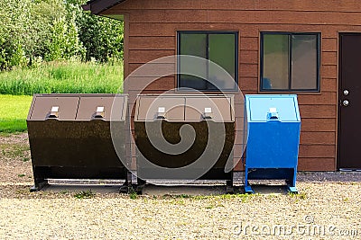 Four bear proof garbage cans with a recycle bin Stock Photo
