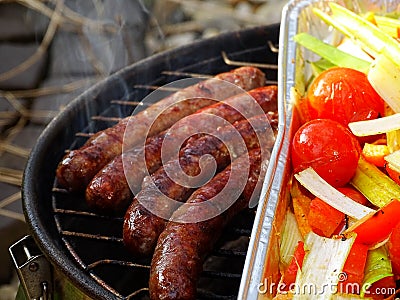 four beef chipolata sausageson the BBQ Stock Photo