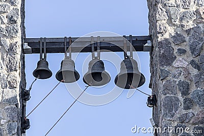 Four bells hang at the Christian church Stock Photo