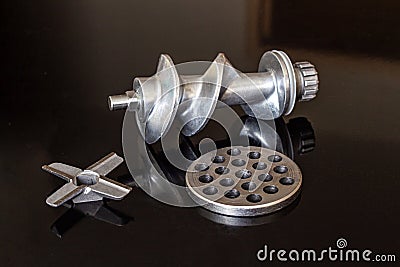 Electric meat grinder parts - four-blade knife, feed screw and grate chopper Stock Photo