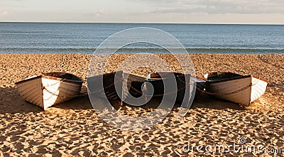 Four boats on the beach. Stock Photo