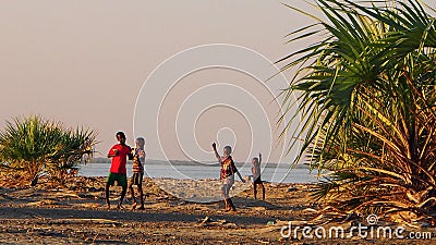 Four boys dancing on the beach at Lake Turkana Editorial Stock Photo