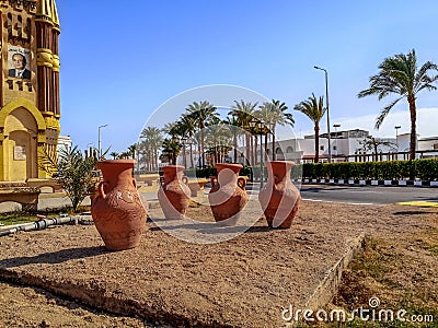 Four brown large clay amphorae stands in the middle of a street in Sharm El Sheikh. Editorial Stock Photo