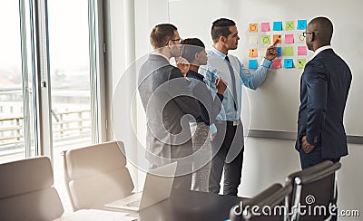 Four business people planning with sticky notes Stock Photo