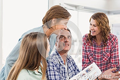 Four casual colleagues using computer Stock Photo