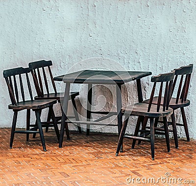 Four chairs and a wooden table Stock Photo
